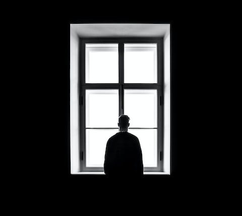 hombre mirando por la ventana