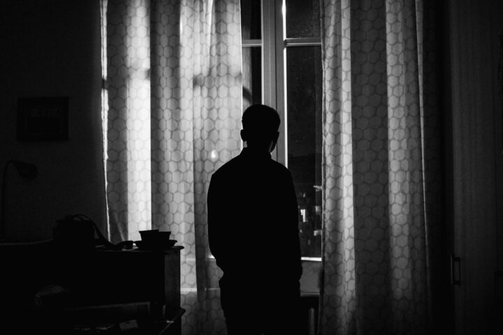 Un hombre mira a través de una ventana